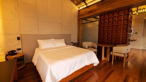 a bedroom with a bed and a table and chairs at Casa Malva Villas in Buenavista