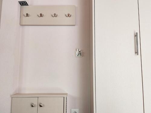 a white room with a cabinet and a shelf at Travelers Stasis Nafpaktos in Nafpaktos