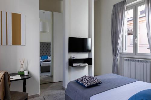 a bedroom with a bed and a television in a room at Now Apartments, ApartHotel in the heart of Rome in Rome