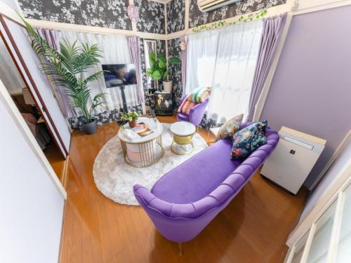 an overhead view of a living room with a purple couch at Shinjuku Area , 3min walk to Nishi-Shinjuku 5-chome, 3min to Shinjuku, Switch, Free Wi-Fi , PocketWi-Fi in Tokyo