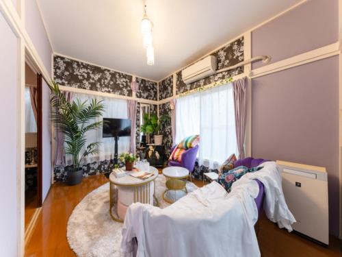 a living room with a couch and a table at Shinjuku Area , 3min walk to Nishi-Shinjuku 5-chome, 3min to Shinjuku, Switch, Free Wi-Fi , PocketWi-Fi in Tokyo