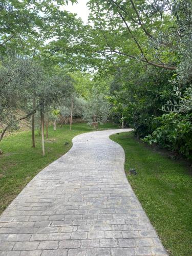 a brick path in a park with trees at Casa Valley Boutique in Melegis