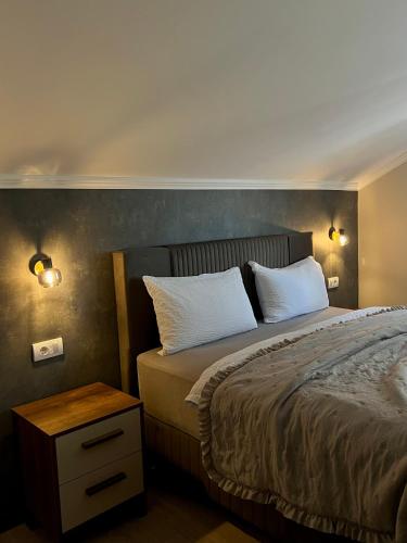 a bedroom with a bed with two pillows on it at Apart Mi in Novi Sad