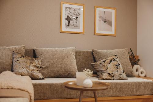 a living room with a couch and a table at Goldhorn Chalet SKI IN&OUT in Kranjska Gora