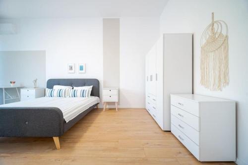 a bedroom with a bed and a white dresser at Mycampus 1 bdrm, stay 4, free parking, garden, self check-in in Sofia