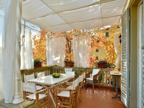 a dining room with a white table and chairs at Spacious Mansion, Casciana in Lari