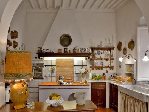 a large kitchen with a sink and a table at Spacious Mansion, Casciana in Lari