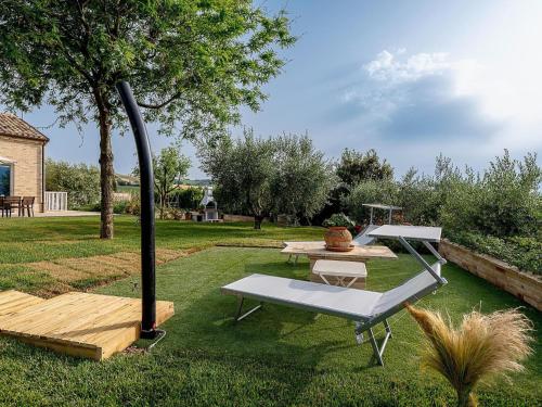 a picnic table and a bench in a yard at Apartment in Montelupone near Porto Recanati in Montelupone