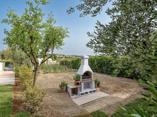 a small white bird house in a garden at Apartment in Montelupone near Porto Recanati in Montelupone
