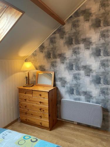 a bedroom with a bed and a dresser with a mirror at Logement Belle vue, Reposant in Lans-en-Vercors