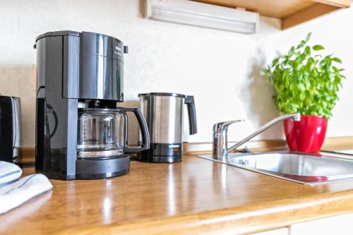 a coffee maker sitting on a counter next to a sink at Atlanta Pur in Pellworm