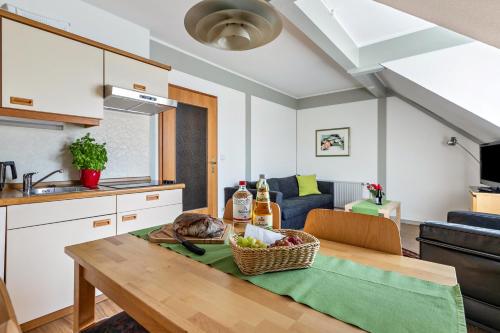 a kitchen and a table with a basket of food on it at Atlanta Pur in Pellworm