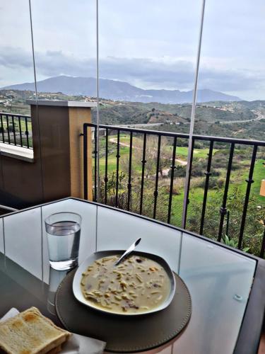 a plate of food on a table with a glass of water at Solo Habitacion Doble en Apartamento A COMPARTIR! in Málaga