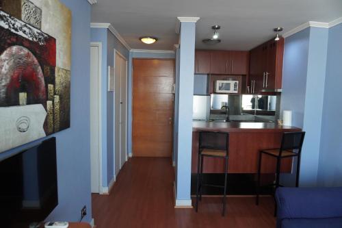 a kitchen with blue walls and a kitchen island at Pontoni Providencia in Santiago