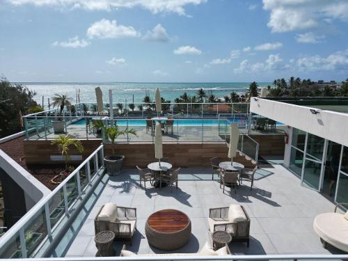 a balcony with a view of a swimming pool at Flats no Nixxus Residence (Flats da Elena) in Porto De Galinhas
