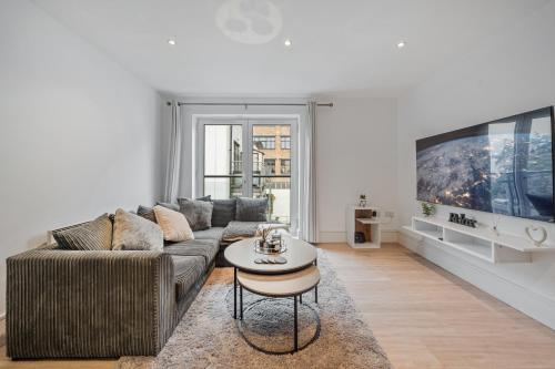 a living room with a couch and a table at 2 Bedroom Apartment in Kings Cross, London, N1 in London