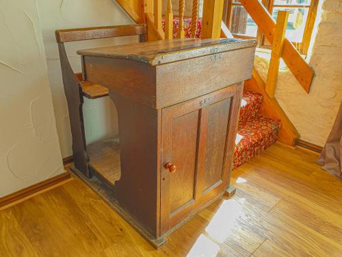 an old wooden podium in a room with a staircase at Clyne Farm Centre in The Mumbles