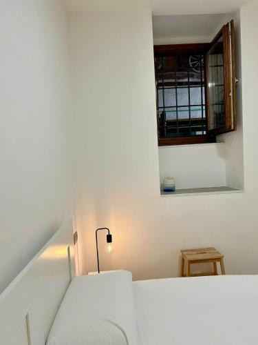 a white room with a bed and a window at Kibilù - Bodio near Lake Varese in Lomnago