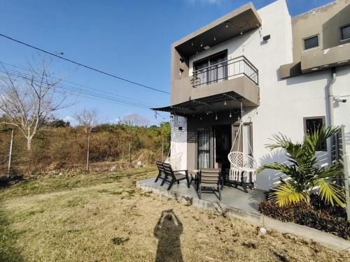 a person standing in front of a house at Green Village in Grand Gaube