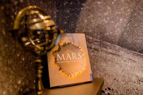 a book sitting on a table next to a trophy at Motel One Nürnberg-Plärrer in Nürnberg