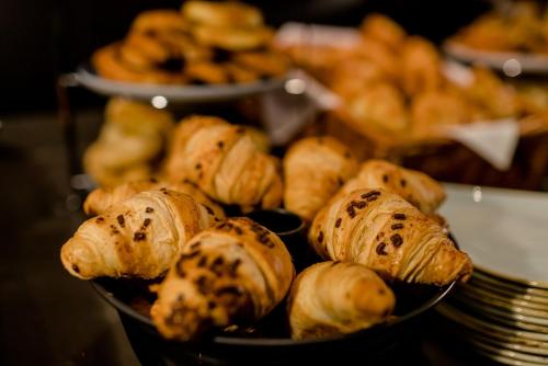 a bunch of pastries in a bowl on a table at Motel One Nürnberg-Plärrer in Nürnberg
