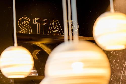 a group of lights in front of a sign at Motel One Nürnberg-Plärrer in Nürnberg