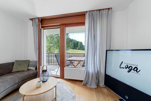 a living room with a couch and a flat screen tv at San Gian C5 in Surlej