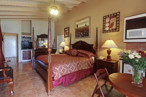 a bedroom with a bed and a table at Mary's Boon Beach Resort & Spa in Simpson Bay