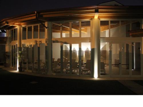 a building with chairs on a patio at night at Hotel Terme Patria in Abano Terme