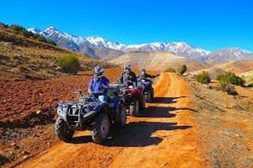 a group of people riding atvs on a dirt road at Dar Noureddine in Lalla Takerkoust
