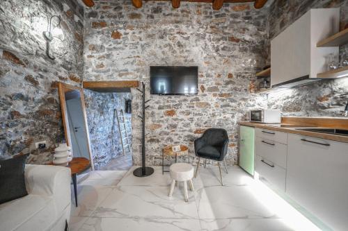 a kitchen with a couch and a table in a room at Petra Elounda Suites - Adults Only in Elounda