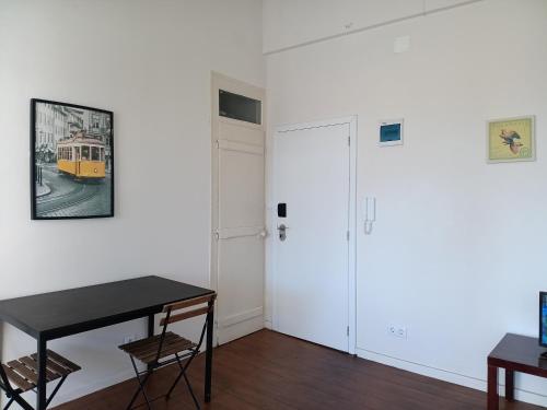 a room with a black table and a yellow bus on the wall at Amoreiras Lisbon Apartments in Lisbon