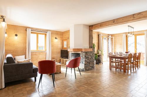 a living room with a fireplace and a dining room at Appartement La Mottuaz in Bessans