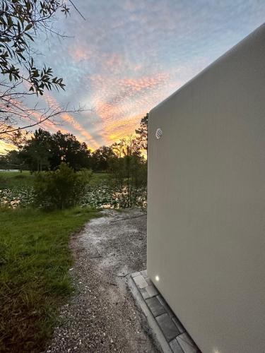 a view of the sunset from the side of a building at Advanced 3D Printed MicroHouse w Panoramic Glass in Bithlo