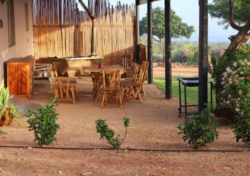 a patio with a table and chairs and a piano at Fossil Hills in McGregor