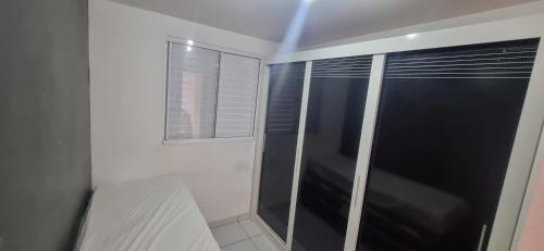 a shower with a glass door in a bathroom at Apê simples, completo e bem localizado! in Hortolândia