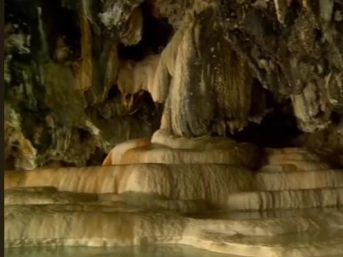 a stone statue in a cave with a waterfall at Armen bed and breakfast in Halidzor