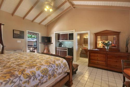 a large bedroom with a bed and a kitchen at Mary's Boon Beach Resort & Spa in Simpson Bay