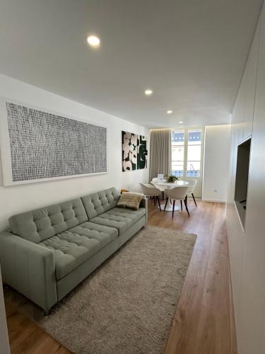 a living room with a couch and a table at Crato Apartments in Viana do Castelo