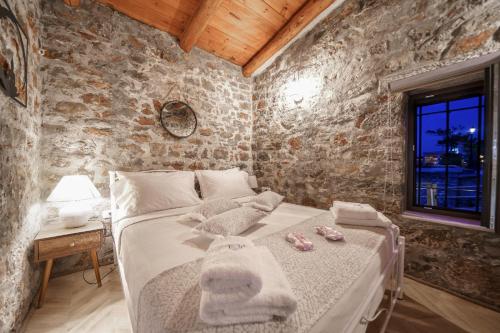 a bedroom with a bed with towels on it at Petra Elounda Suites - Adults Only in Elounda