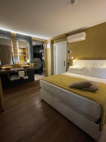a bedroom with a large bed and a bathroom at Mamma Mia Hotel Boutique - Only Adults in Tossa de Mar