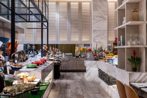 a buffet line in a restaurant with food on display at Medellin Marriott Hotel in Medellín