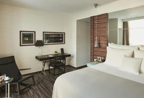 a hotel room with a bed and a desk at ROMEO Napoli in Naples