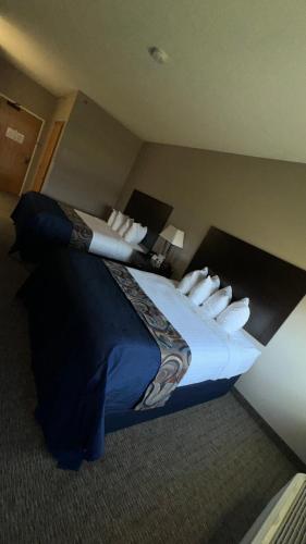 a bedroom with a large bed in a hotel room at Garner INN & Suites in Garner