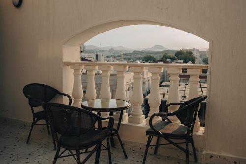 a table and chairs on a balcony with a view at Armada Residence Hotel in Taif