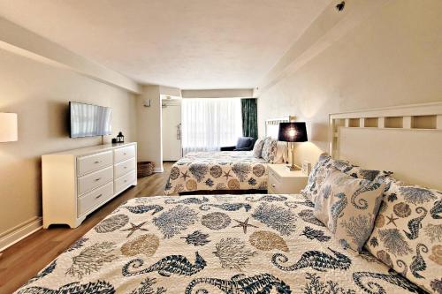 a bedroom with two beds and a dresser at Daytona Beach Resort Unit #302 in Daytona Beach