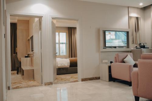 a hotel room with a bedroom and a living room at Armada Residence Hotel in Taif