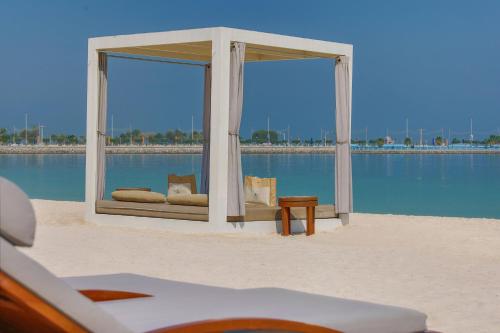 a room with two windows on the beach next to the water at The St. Regis Abu Dhabi in Abu Dhabi