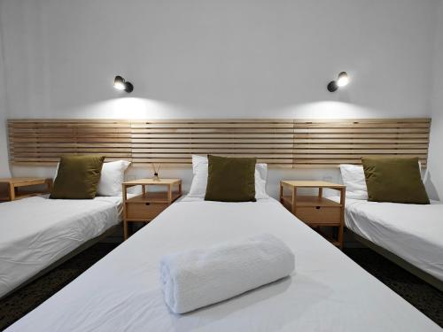 a room with two beds and two tables at Cosy room 1 in Pieta
