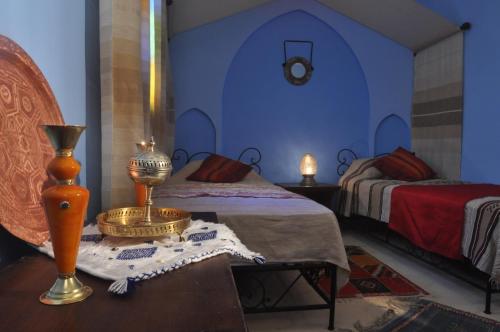 Postel nebo postele na pokoji v ubytování Riad La Famille